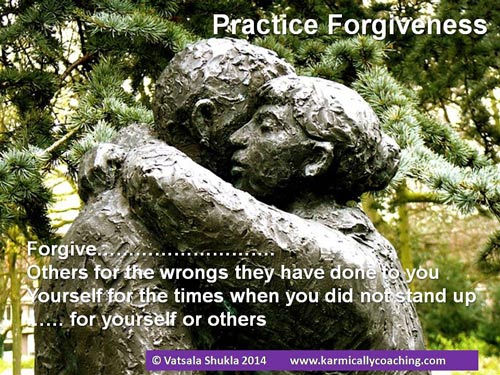 Stone statue in a park of a woman embracing a man in forgiveness