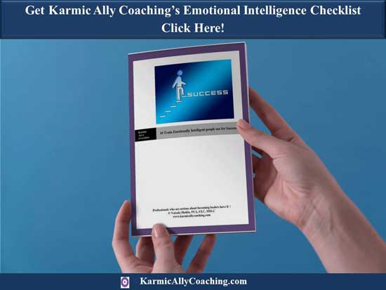 Hands holding copy of Karmic Ally Coaching's free Emotional Intelligence Traits Checklist 