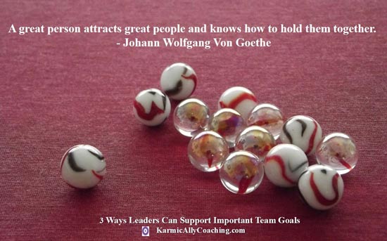Leader and team of marbles with Goethe quote on leaders