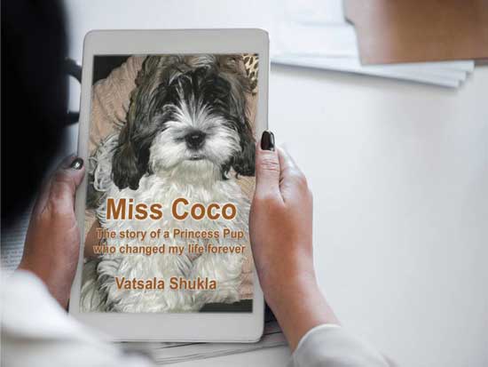 Woman holding Kindle ebook about Miss Coco