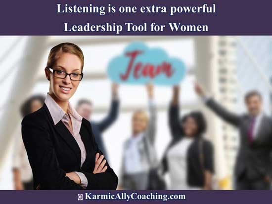 Smiling Woman leader with team pointing to banner in the background Smiling Woman leader with team pointing to banner in the background