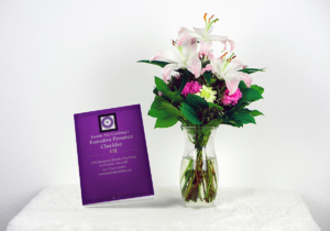 Karmic Ally Coaching's Executive Presence Checklist against flowers in a vase